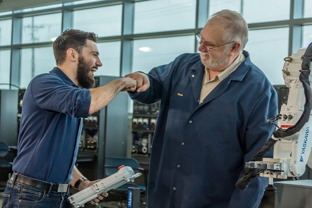 student and his instructor fist-bumping