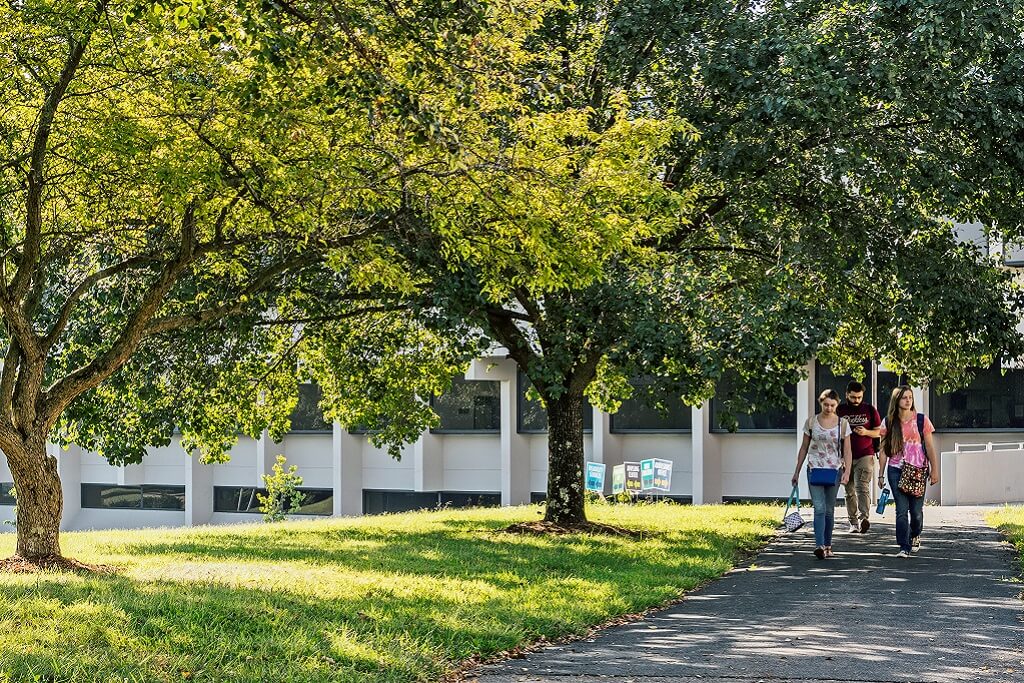 Three students walking outside of College Drive Campus