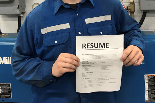 Close up of a Resume held by a student