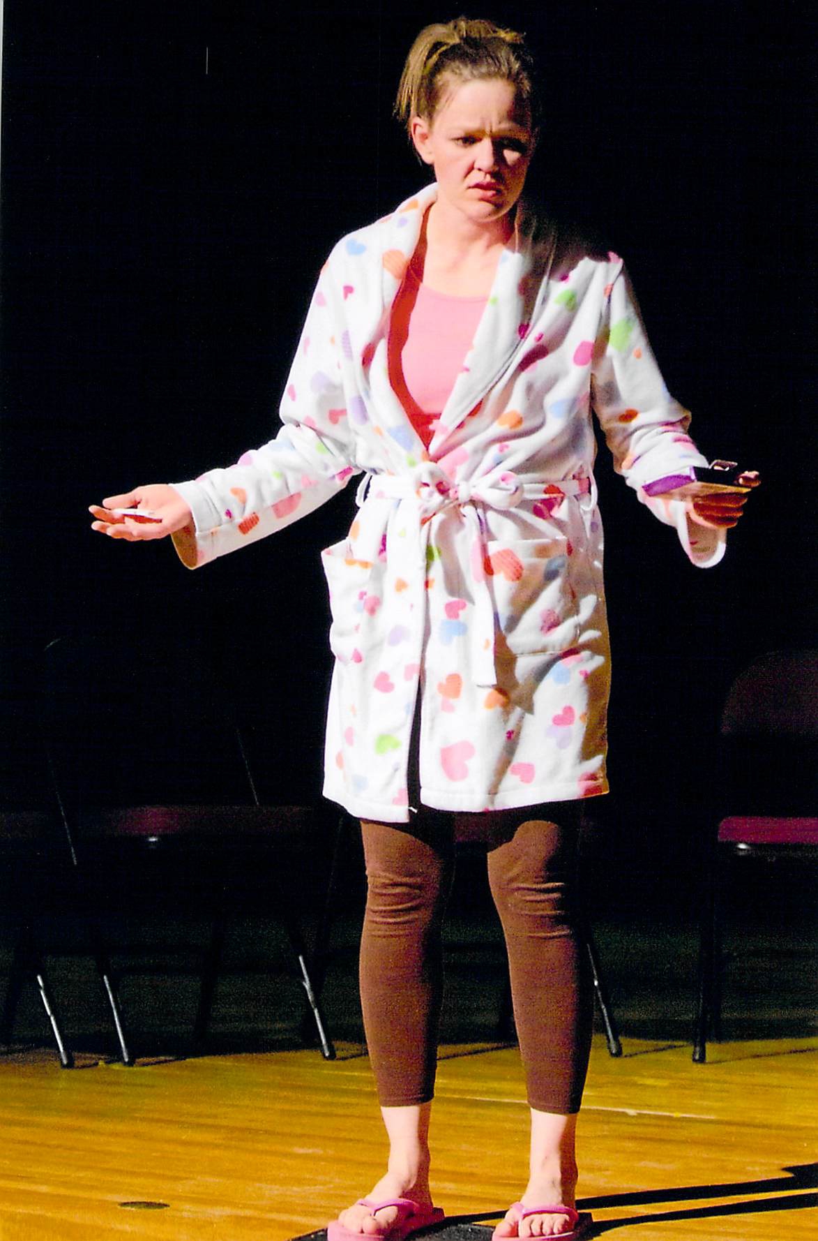 Woman on stage in Bathrobe