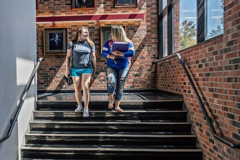Two students taking a tour through College Drive Campus
