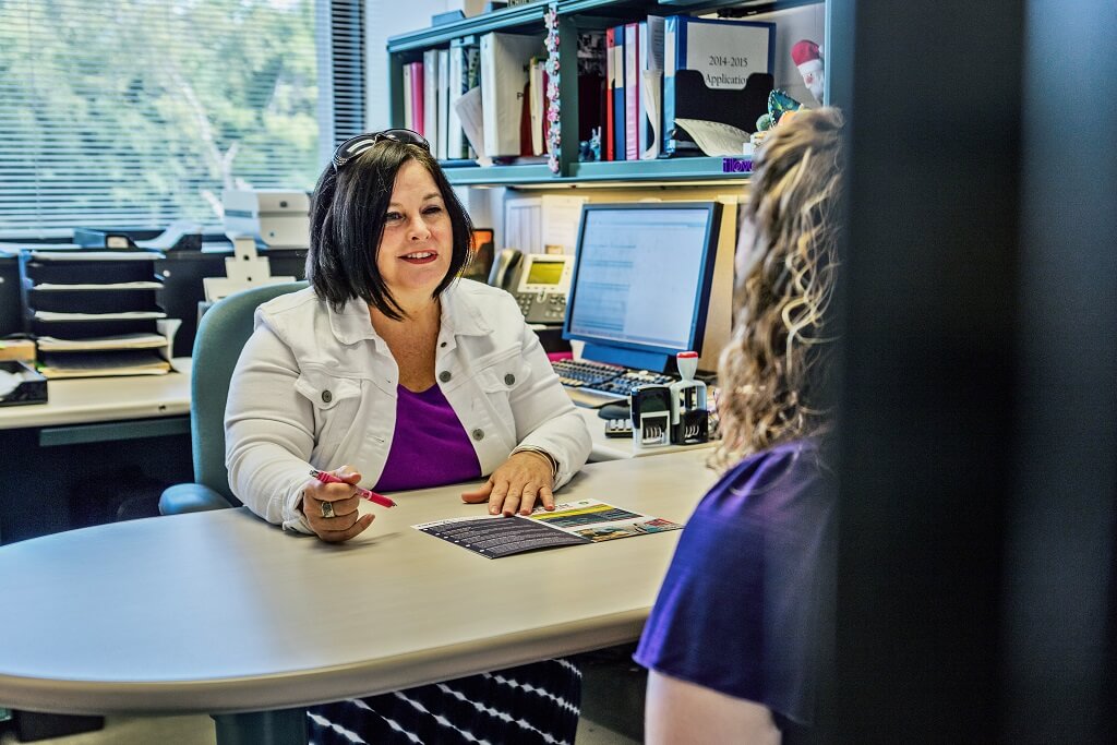 financial aid advisor helping student