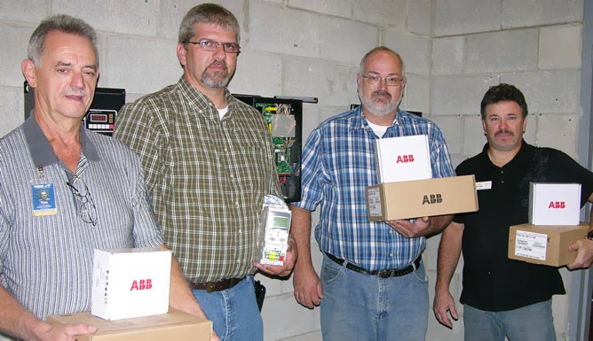 ACTC faculty and representtives from ABB Inc. hold some of the equipment donated to the school by ABB Inc.