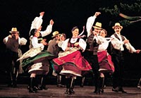 Wearing authentic dress member of the Hungarian State Folk Ensemble performs a traditional dance.