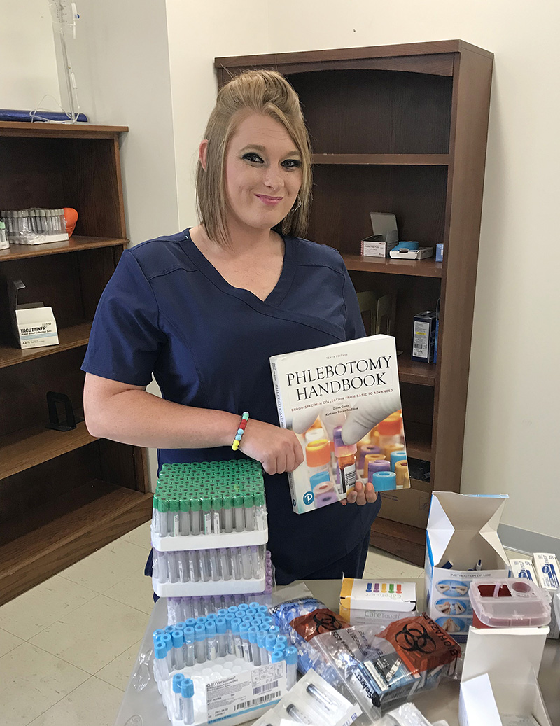 student holding textbook