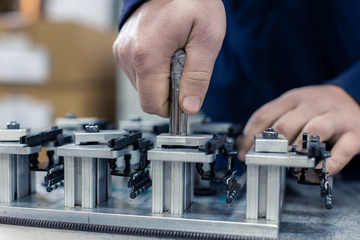 student machinist piecing together metal project